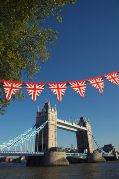 Classic Blue Sky View Of Tower Bridge With Vintage Union Jack Bunting In London, UK