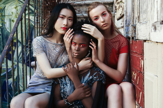 Portrait of young fashion models different races together. African, European and Chinese. Globalisation and mix race in the World concept