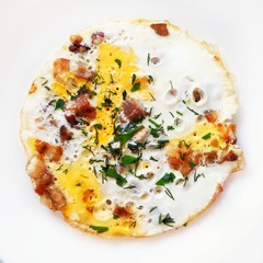 Omelet with eggs, bacon (brisket) and herbs on a white background. Recipe for a healthy diet and breakfast. Close-up, top view.