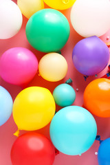 Many different balloons on color background