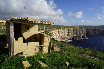 Fototapeta na wymiar Gozo cliffs, beautiful, stunning view from the walking path around Gozo; after dry summer the island starts to be green during the autumn