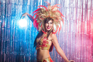 Carnival, dancer and holiday concept - Beauty brunette woman in cabaret suit and headdress with...
