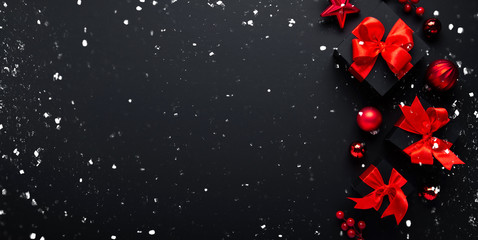 Christmas and New Year holiday background. Xmas greeting card. Christmas gifts on black background top view.