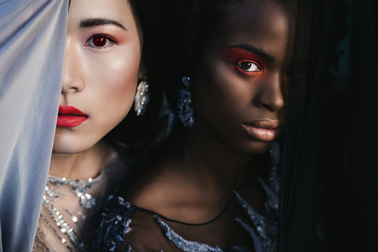 Portrait of two young fashion models different races together. African and Chinese. Globalisation and mix race in the World concept