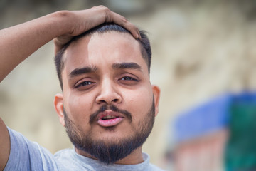 Fototapeta premium Photo of handsome Indian, asian youth with content and satisfied look.