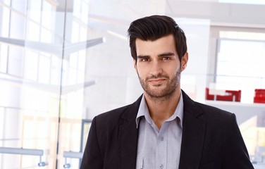 Smiling businessman in business interior