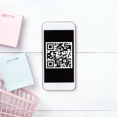 Abstract online shopping, mobile payment with QR code design concept element, colorful cart, paper bag on wooden table background, top view, flat lay