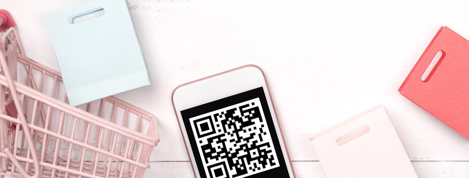 Abstract online shopping, mobile payment with QR code design concept element, colorful cart, paper bag on wooden table background, top view, flat lay