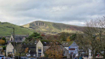 Rooftops of Castleton, Peak District, UK looking towards Mam Tor paragliders