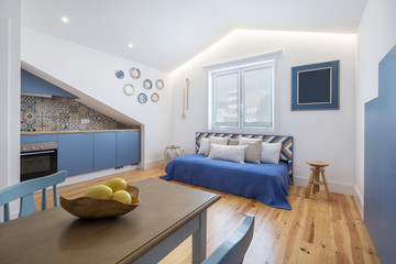 Modern apartment interior design in blue colours,  small and cozy bed room, yellow lemons on the...