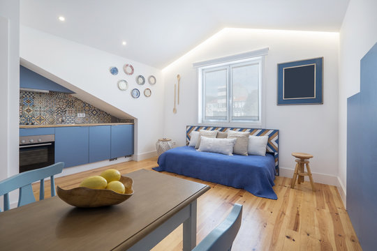 Modern apartment interior design in blue colours,  small and cozy bed room, yellow lemons on the table