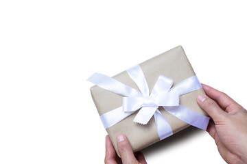 Isolated man holding brown gift box with white ribbon on white background. File contains clipping path.