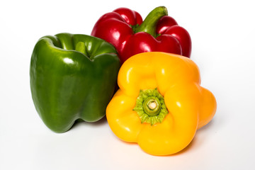 Three Red, Yellow, Green Peppers isolated on white background.