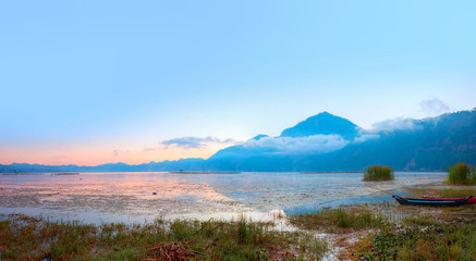 Fishing village on the coast of the Lake Batur on the background amazing sunset - Bali island, Indonesia