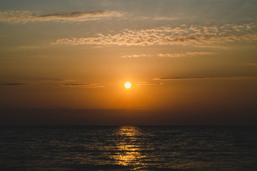 The bright orange sun in the sky