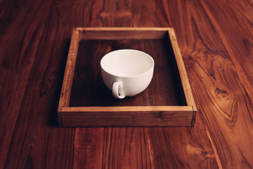 White empty  cup on wooden background