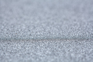 Silver glitter abstract background with shallow focus and copy space
