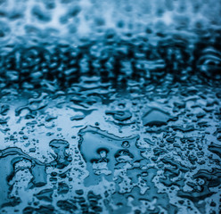 Water texture abstract background, aqua drops on blue glass as science macro element, rainy weather...