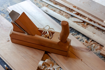 Joiner tool - close-up wooden jointer. Boards, shavings, light wood sawdust