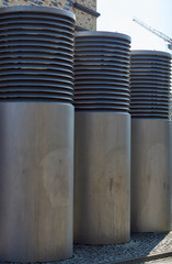 Air silos in front of blue sky, city development