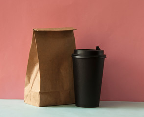 Brown recyclable paper bags and black coffee cup for mockup template advertising and branding background.