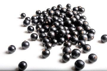 Heap of black currant berry. Blackcurrant on white background. Currant macro photo.