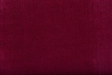 tissue structure closeup. fine grain felt ruby fabric. Fabric background. Red fiber texture polyester close-up.