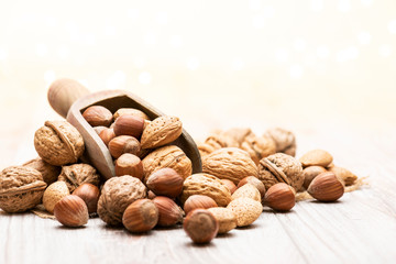 variety of nuts with wooden scoop on table