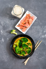 Boiled broccoli, shrimp, rice on a concrete background. Healthy eating concept. Sports diet. A set of ingredients for proper nutrition. Healthy lifestyle. Copy space. Top view.