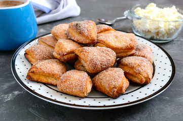 Tasty curd cheese cookies on a plate. Goose foot cookies. Homemade cakes and coffee for breakfast.