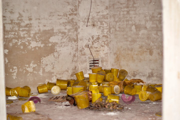 Yellow buckets inside of abandoned WWII bunker
