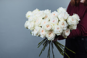 Close-up of white roses. A girl holding a rose. Flowers