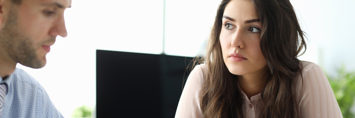 Portrait of serious businesswoman sitting in modern corporation office and looking at attractive...