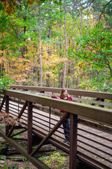 woman standing on bridge in Autumn