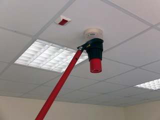 Narva, Estonia  03.04.2019 , Office room . Fire alarm system service. Professional Smoke Detector Tester 