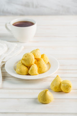 Banana meringue in a white plate and a Cup of tea on a light background. Sugar-free