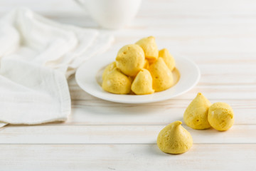 Banana meringue in a white plate and a Cup of tea on a light background. Sugar-free