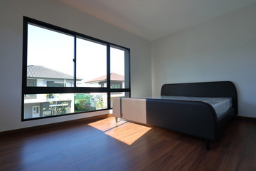 Fototapeta na wymiar empty modern bedroom with wood laminate floor in residential house