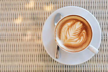 hot latte coffee drink put on white table in cafe restaurant