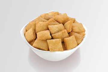 Shakkar pare Also Know as Shakkarpare, Shakarpare, Shakarpali, Shakkar Para, Sakarpara or Shankarpalli or shankar pale is a Snack Typically Made in India During Diwali - Image