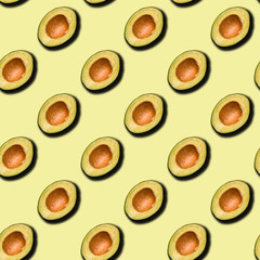 Seamless pattern. Seedless avocado on a green background.
