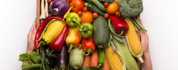 Close up of wooden box full of fresh and tasty vegetables