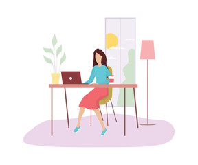 Woman in sitting at the desk and working on the computer.