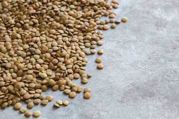 Green lentils close-up on a gray background.