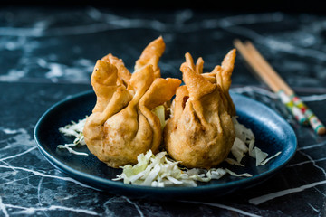 Nepalese Traditional Deep Fried Dumpling Momos served with Tomato Chutney, Schezwan sauce and Cabbage salad.