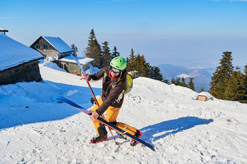 Clumsy funny skier dropping his wide skis. Location: Poiana Brasov ski resort, Romania. - obrazy, fototapety, plakaty