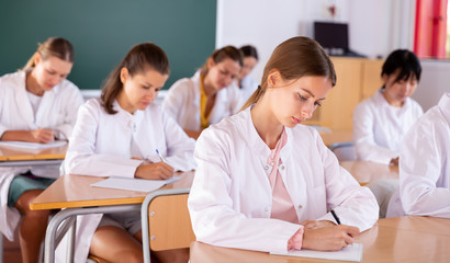 Fototapeta premium Medical students writing in notepads