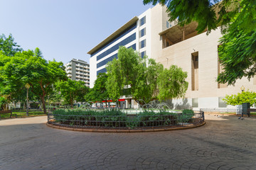 Fototapeta premium City landscape. Green square with a cool fountain. Almeria, Andalusia, Spain