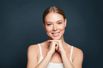 Perfect woman face on blue background. Healthy woman model smiling
