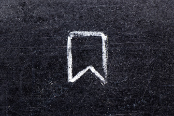 White chalk hand drawing in ribbon banner shape on black board background